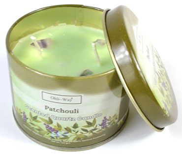 Patchouli quartz candle tin in green with floral design from www.Wolfmoon.store with lid partially open