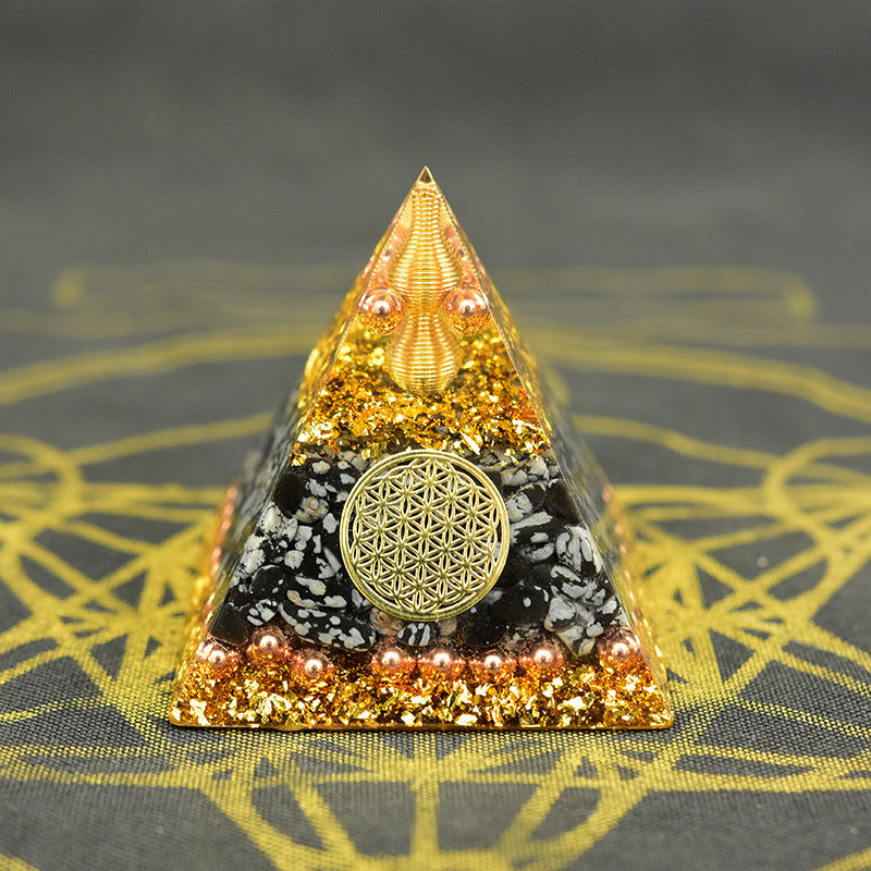 Reiki orgonite pyramid with intricate designs and golden elements for energy healing and decor