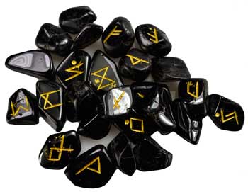 Black tourmaline rune set with yellow engraved symbols for divination and spiritual practices