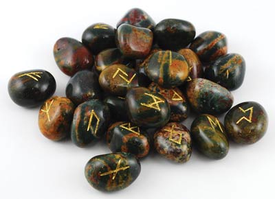 Bloodstone rune set featuring polished stones with golden inscriptions for divination and spiritual practice