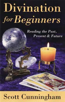Divination for Beginners book by Scott Cunningham on crystal ball and tarot cards with candle