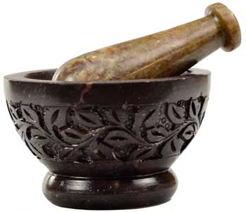 Intricately carved flower mortar and pestle set in dark stone for grinding herbs and spices