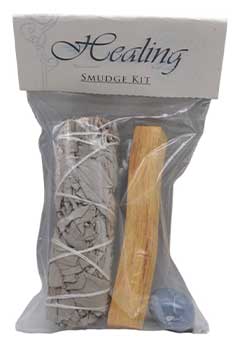 Healing smudge kit featuring sage bundle, wooden stick, and a candle for spiritual cleansing