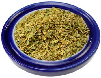 Dried linden flower cut herb in a blue dish, perfect for soothing herbal teas and remedies