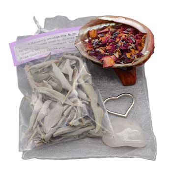 Love and relax smudge kit featuring herbs, dried flowers, and a heart-shaped crystal for calming energy