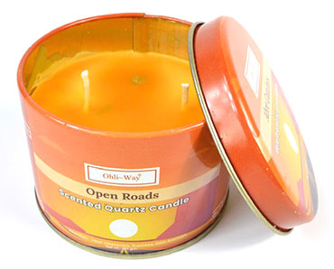 Abre Caminos quartz candle in an orange metal tin with two wicks and scented wax