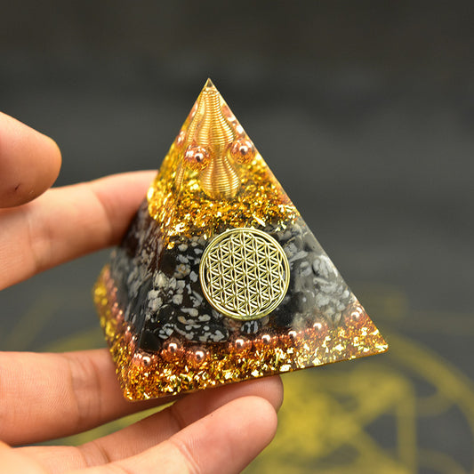 Reiki orgonite pyramid featuring a decorative design and vibrant colors for energy healing