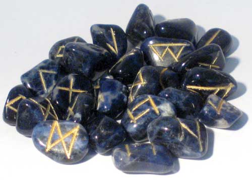 Sodalite rune set featuring polished blue stones with gold markings for divination and spiritual guidance